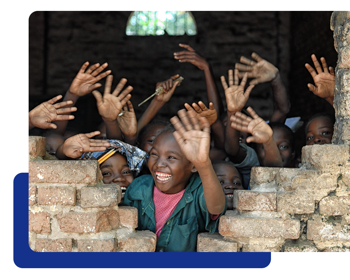 SOS Villages Picture of of children smiling and waving.