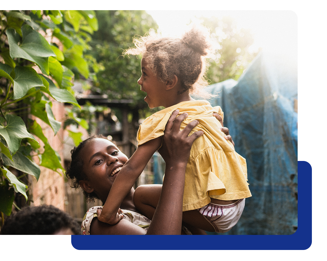 Global Medical Picture of a mother holding daughter, and both are happy and smiling.
