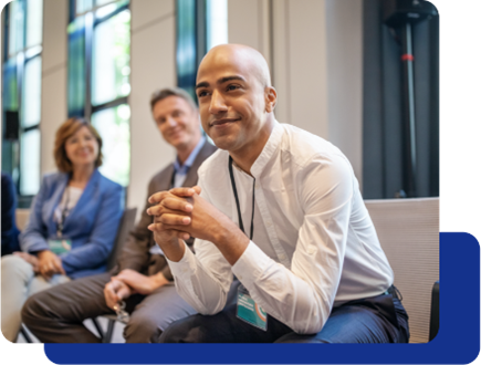 group-of-people Three professionals sitting at a conference smiling.