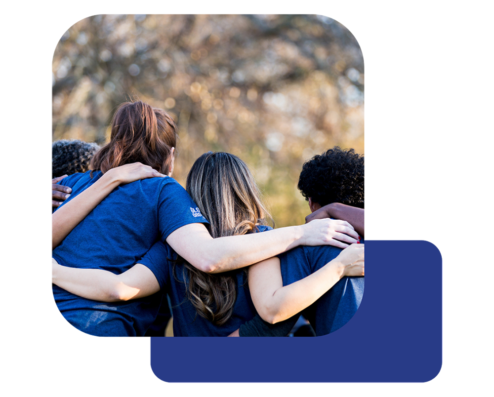 group-of-people Three Pure Encapsulations employees with arms wrapped around each other posing for a photo.