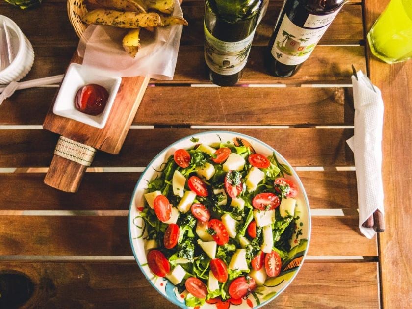 Healthy salad with tomatoes, spinach, cheese, balsamic with olive oil and bread