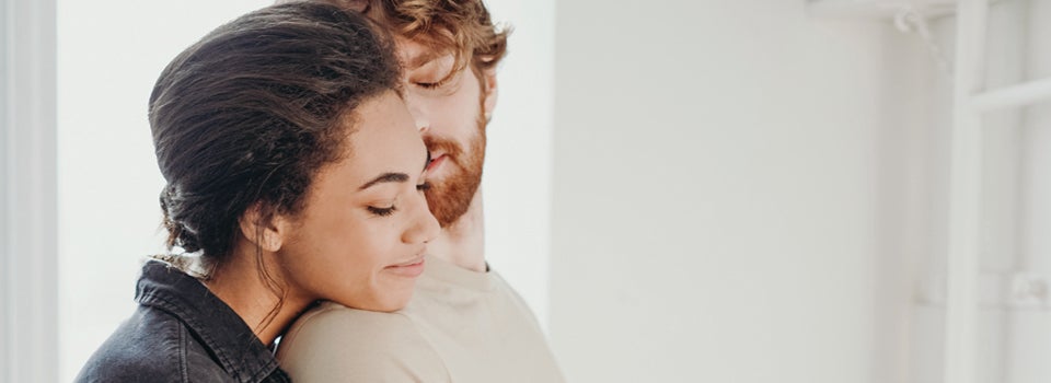 A man and women hugging and smiling