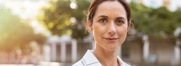 A women smiling outside