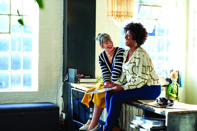Two friends laughing and smiling together