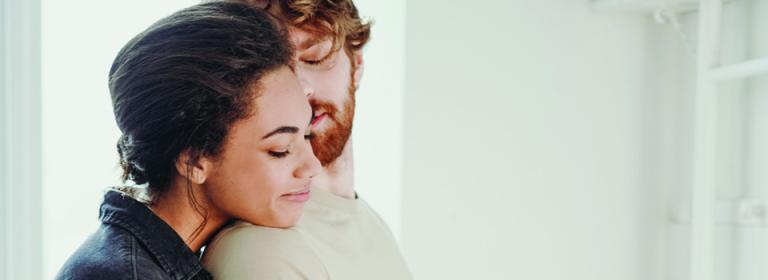 A man and women hugging and smiling