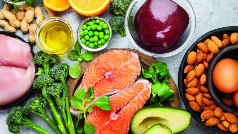 Healthy foods like salmon, chicken, avocado, nuts, fruits and vegetables.