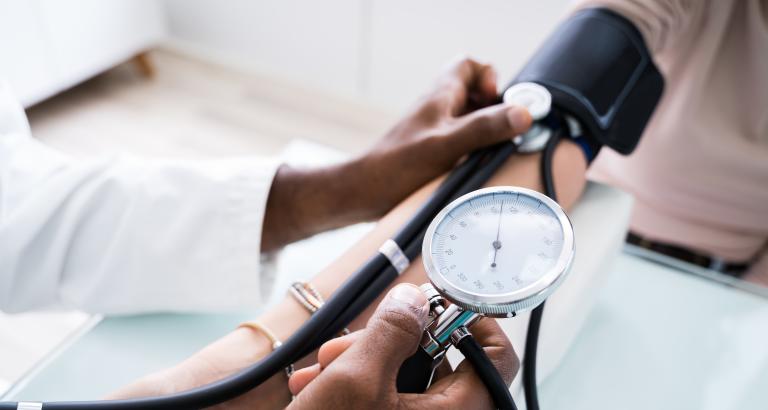 Doctor measuring blood pressure of a patient