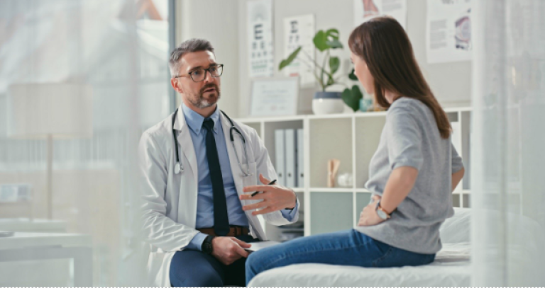 Male doctor talking to his female patient for an appointment.