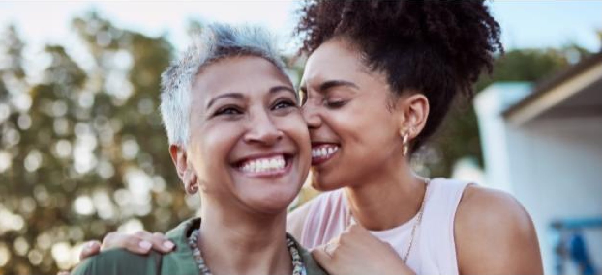 Mother and daughter hugging and smiling