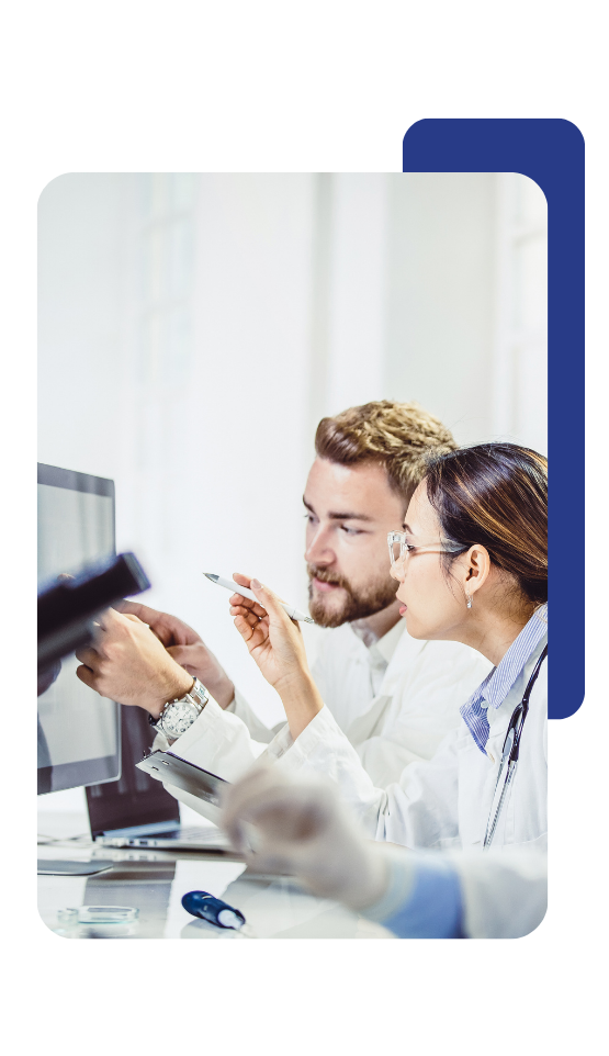 Two laboratory technicians working and analyzing data.